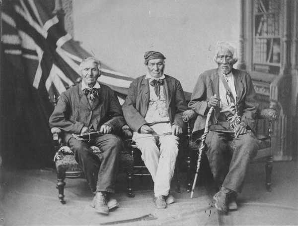 Original title:    Description English: 1882 studio portrait of the (then) last surviving Six Nations warriors who fought with the British in the War of 1812: (left to right) Sakawaraton a.k.a. John Smoke Johnson (born circa 1792), John Tutela (born ca. 1797) and Young Warner (born ca. 1794). Portrait taken in Brantford, Ontario, Canada. Français : Portrait de studio pris en juillet 1882 des guerriers survivants des Six-Nations qui ont combattu aux côtés des Britanniques au cours de la guerre de 1812. Date July 1882(1882-07) Source This image is available from Library and Archives Canada under the reproduction reference number C-085127 and under the MIKAN ID number 3630023 https://recherche-collection-search.bac-lac.gc.ca/eng/home/record?idnumber=3630023&app=fonandcol 